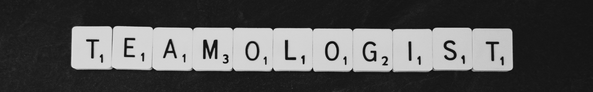 Scrabble tiles spelling "TEAMOLOGIST"